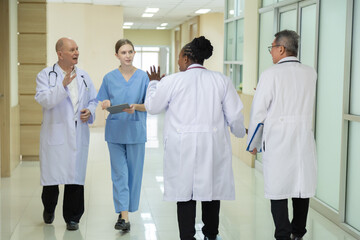Hospital, healthcare, medical, doctor, nurse walk together in hallway, multiracial group of professionals communicating team, building trust and friendly teamwork in clinical setting, occupation