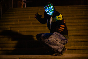 Purge mask, halloween with pumpkin. LED mask, creepy scary man. Corona, Funny, October, outside