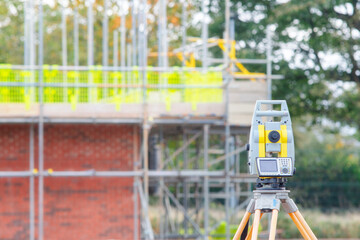 Land surveyors equipment theodolite or total positioning station set by engineer on tripod at...