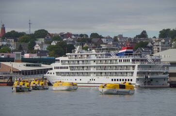 Small American cruiseship cruise ship liner yacht Constitution docked at terminal in downtown...