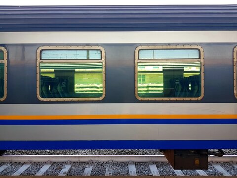 Train station platform with blue and yellow train. Railway station platform.