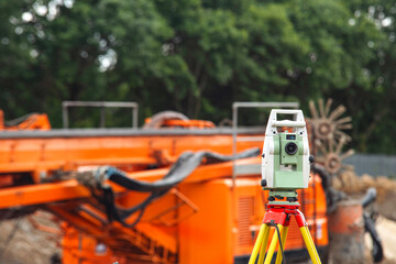 Land surveyors equipment theodolite or total positioning station set by engineer on tripod at...