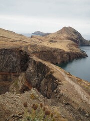 Desert landscapes of Cape Sao Lourenco. A narrow path over a cliff. Nature of Madeira Island, Portugal, PR8 Vereda da Ponta de Sao Lourenco.