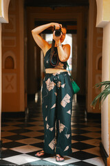 Photographer woman taking photos with a digital camera while on vacation