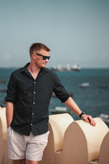 Summer fashion smart casual male model wearing sunglasses