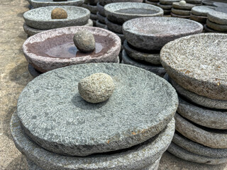 Stacked Round Stone Grinding Plates with Pestles