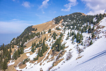 Landscape photo of an uphill climb in spring. Typical landscape in sunshine in the German Alps.