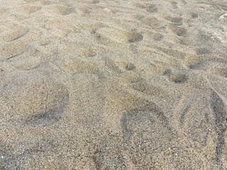 Textured Beach Sand with Footprints