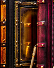 Large black and purple leather books with a golden fountain pen. Pen reflection in a polished brass...