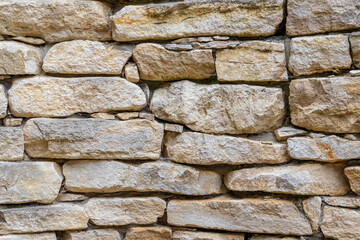 Old stone wall made of irregularly shaped blocks, texture, architecture, construction, background,...