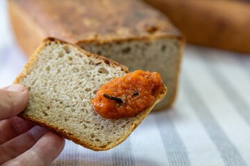 Rustic colonial rye bread, with chimia or pumpkin jam. Well-lit image, clear selective focus on the details of the texture of the bread and the jam, conveying tradition, rusticity and homemade flavor