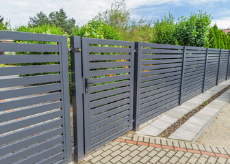 Modern metal fence with garden gate