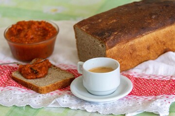 Rustic colonial rye bread, with chimia or pumpkin jam. Well-lit image, clear selective focus on the...