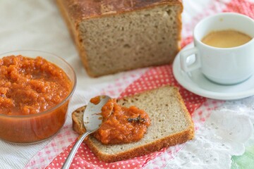Rustic colonial rye bread, with chimia or pumpkin jam. Well-lit image, clear selective focus on the...