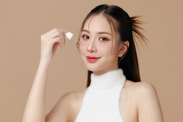 Beautiful portrait Asian Thai woman makeup of cosmetic and Apply serum on face smile attractive isolated on beige background.