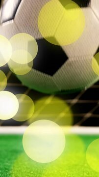 Animation of falling glowing lights over football ball