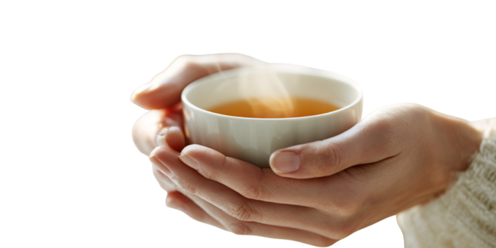 Womans hands holding a steaming cup of tea indoors, providing warmth and comfort Concept of relaxation, selfcare, and wellness during a cozy morning