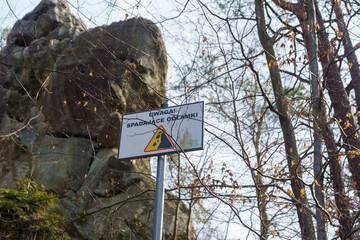  warning sign about falling rock fragments in the Prządki rock reserve, Poland