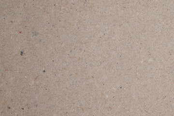 Recycled cardboard paper texture with colored fibers
