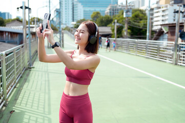 Young Woman Enjoys Jogging While Listening to Music in an Urban Park During the Afternoon