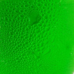 Close up view of numerous tiny water droplets on a vibrant green surface