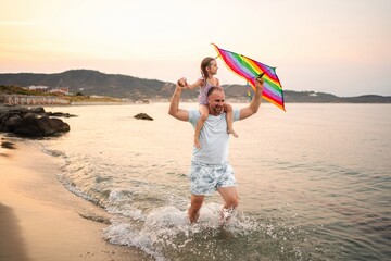 Joyful moments of family fun at the beach on a sunny evening