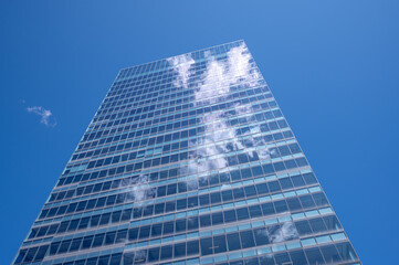 Clouds reflected in the windows of a modern office building.
