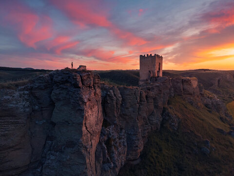Man in Oreja Castle at sunset with scenic cliffs in Ontigola