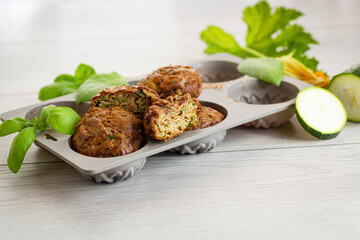 Homemade zucchini pastries on a light wooden table