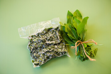 Vacuum packaging with sorrel and fresh greens nearby