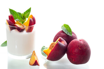 Ripe juicy nectarines in homemade yogurt isolated on white background