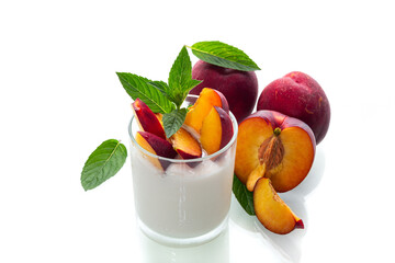 Sweet yogurt and juicy nectarines with red skin on white