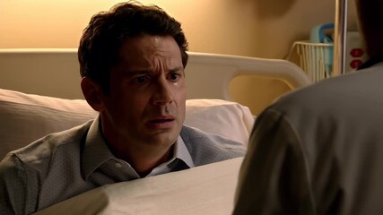 Middle-aged White man talking with doctor while expressing worry in hospital room - warm tones and emotional tone - healthcare and human vulnerability