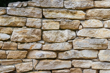 Old stone wall made of irregularly shaped blocks, texture, architecture, construction, background,...