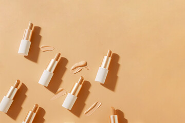 Foundation tubes and cosmetic bottles arranged in seamless pattern