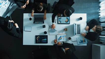 Fototapete Top down aerial view of smart boss invites project manager to explain about marketing plan at white board. Group of diverse investor listen presentation while working and analyze chart. Directorate. © InfiniteFlow