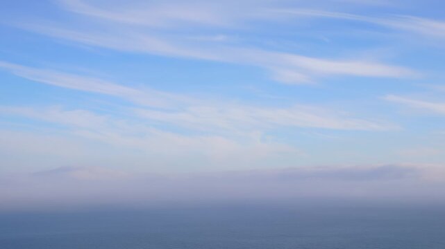 Sea Fog Rolling In with Evening Clouds. Ocean View Obscured by Approaching Mist. Evening Clouds and Encroaching Haze. Sea and Sky Blending in Soft Fog