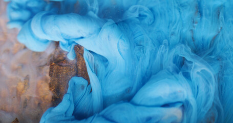 Underwater fume. Ink background. Blur blue color smog twirling pigment particles spreading on...