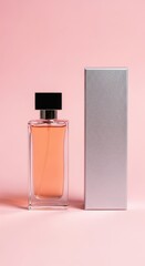 Elegant perfume bottle and silver box stand on a soft pink background