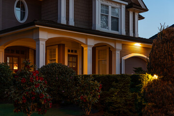 Entrance of luxury house with nice spring blossom landscape at night in Vancouver, Canada, North America. May 2025.