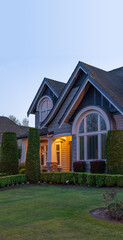 Entrance of luxury house with nice spring blossom landscape at night in Vancouver, Canada, North America. May 2025.