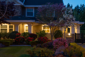 Entrance of luxury house with nice spring blossom landscape at night in Vancouver, Canada, North America. May 2025.