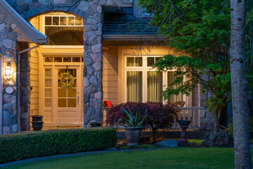 Entrance of luxury house with nice spring blossom landscape at night in Vancouver, Canada, North...