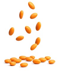 orange pills on white background
