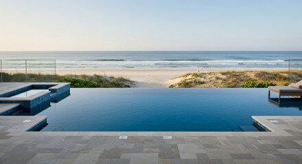 Fototapeta premium Serene Oceanfront Infinity Pool with Spa and Lounge Chair