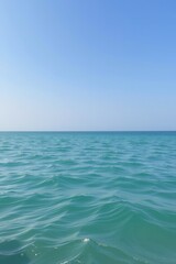 Tranquil Ocean Waves Under Clear Blue Sky on Sunny Day