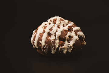 Profiteroles with coconut cream on a black background.