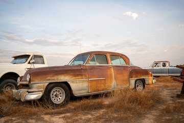 Rusty Brown Classic Sedan in Junkyard