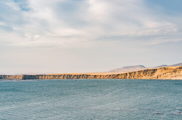 Dramatic landscape with the rocky coastline of the Pacific ocean in Paracas National Reserve, Peru.