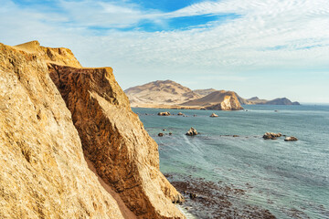 Dramatic landscape with the rocky coastline of the Pacific ocean in Paracas National Reserve, Peru.